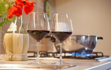 two glasses of red wine on  kitchen table