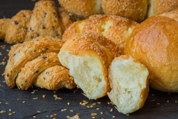 Traditional homemade bakery bread with sesame, Stack of fresh bread on stone table