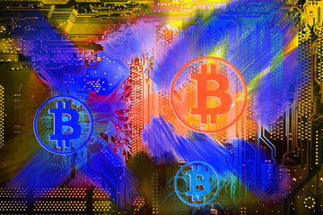 Bitcoin on the background of the electronic circuit of the PC motherboard. Abstract concept of digital currency.
