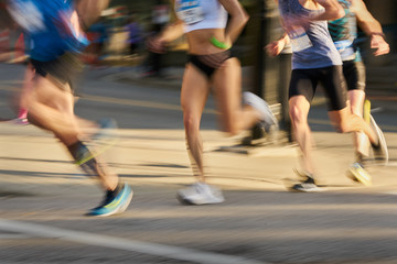 Runners in an Urban Running Race. Competitors in a running race. Motion blur.

