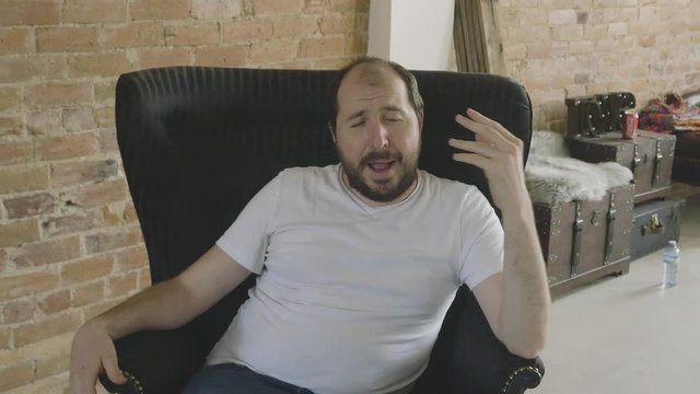 A self confident man tells a story to the camera in a medium shot.