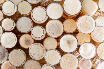 Assortment of full, frothy beer glasses and sizes