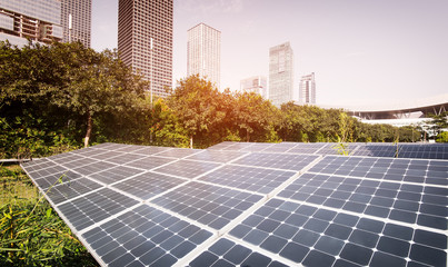 Fototapeta premium solar panel plant with urban landscape landmarks,Ecological energy renewable concept.