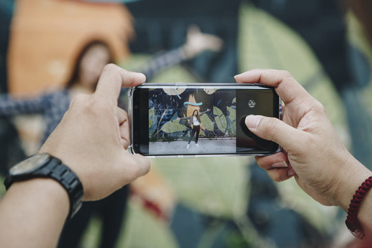 Man taking a photo of his girlfriend