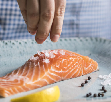 A Person Seasoning A Fillet Of Salmon Food Photography Recipe Idea