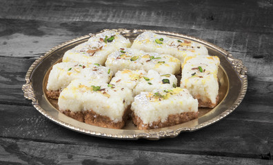 Indian Diwali Sweet Food Kalakand Also Know as Halwa or Mawa Kalakand is a Creamy Delicacy Made From Paneer or Cottage Cheese, The Dish Originated in Alwar, Rajasthan. Kalakand on Wooden Background