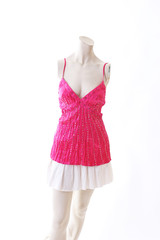 Pink dress long top mini dress on mannequin full body shop display. Woman fashion styles, clothes on white studio background.