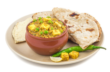 Indian Cuisine Mattar Paneer is a Vegetarian North Indian Dish Consisting of Peas And Paneer in a Tomato Based Sauce, Spiced with Garam Masala. It is often Served with Indian type of Tandoori Roti