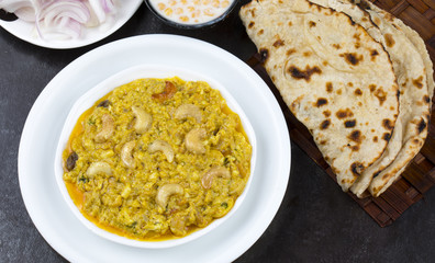 Indian Traditional Vegetarian Cuisine Kaju Curry Also Called Kaju Butter Masala Served with Tandoori Roti, Raita, Salad And Papad