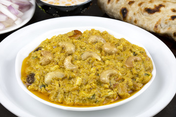 Indian Traditional Vegetarian Cuisine Kaju Curry Also Called Kaju Butter Masala Served with Tandoori Roti, Raita, Salad And Papad