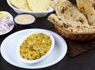 Indian Traditional Vegetarian Cuisine Kaju Curry Also Called Kaju Butter Masala Served with Tandoori Roti, Raita, Salad And Papad