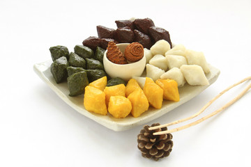 Traditional Korean half-moon-shaped rice cake decorated with pine cone. Holiday food. 