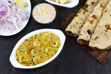 Indian Traditional Vegetarian Cuisine Kaju Curry Also Called Kaju Butter Masala Served with Tandoori Roti, Raita, Salad And Papad