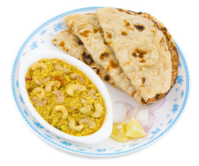 Indian Traditional Vegetarian Cuisine Kaju Curry Also Called Kaju Butter Masala Served With Tandoori Roti And Salad isolated on White Background