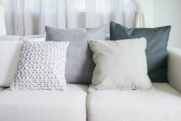 Light gray sofa set with pillows in modern interior living room