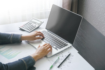 female accountant typing message with computer laptop in home office .concept of business people work from anywhere with technology