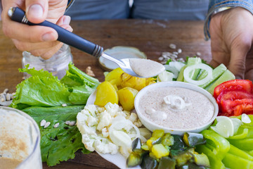 Healthy buddha bowl with vegetables and vegan mayonnaise (flax seeds, mustard, olive oil, lemon...
