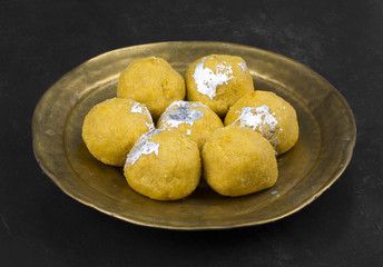 Besan Laddu Indian Traditional Sweet Food Also Know as Laddoos, laddoo, ladoo, laddo Are Ball-Shaped Sweets Popular in The Indian Festivals. Laddu on Black Textured Background