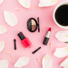 Obraz na płótnie Canvas Beauty composition with tulips flowers, coffee cup and makeup cosmetics on pink background. Top view. Flat lay.