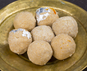 Gehu Ke Laddu Indian Traditional Sweet Food Also Know as Wheat Laddu, Laddoos, laddoo, ladoo, laddo Are Ball-Shaped Sweets Popular in The Indian Festivals. Laddu on Black Textured Background