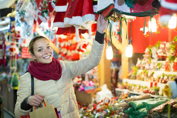 girl shopping at festive fair before Xmas in evening time