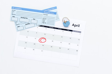 Plan a trip. Buy airplane tickets. Tickets near calendar with date circled on white background top view copy space