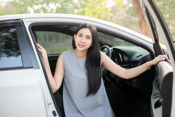 Pretty female driver in a white car