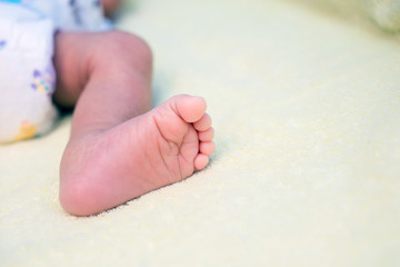 Baby feet on bed, closeup