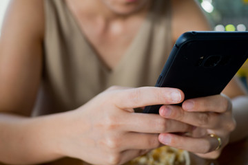 close up hand typing smartphone with copy space for text, shopping online, sending email, play phone