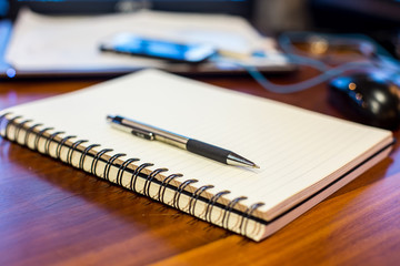 notebook and pen on a wooden table