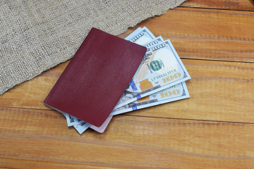 Passport with money (dollars) for vacation lies on the table