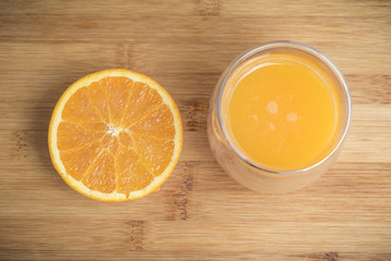 Orange fruit and glass isolated on a wooden background
