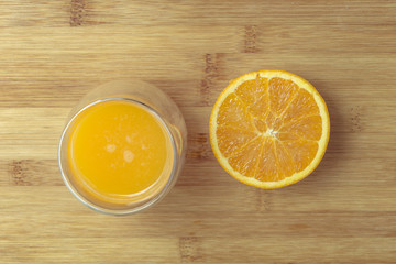 Orange fruit and glass isolated on a wooden background