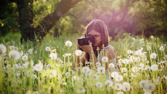 A young photographer, girl photographer of twelve years takes pictures of nature. Slow motion shot