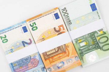 Stack of various euro banknotes isolated on white background.