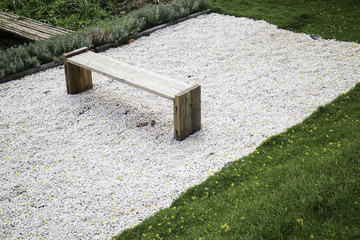 Wooden bench in rock garden