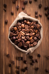 Fresh roasted coffee beans in burlap sack