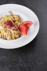 Italian paste of carbonaria with mushrooms with cream sauce on a white plate