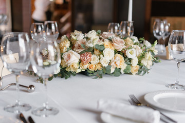 Luxury wedding reception. Flower arrangement on table in restaurant. Stylish decor and adorning.