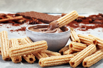 Traditional Spanish dessert churros with sugar and chocolate