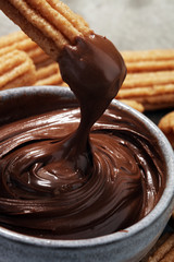 Traditional Spanish dessert churros with sugar and chocolate