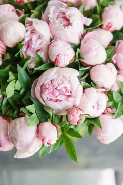 Lovely flowers in glass vase. Beautiful bouquet of pink peonies . Floral composition, scene, daylight. Wallpaper. Vertical photo