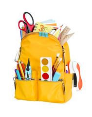 Yellow school backpack with school supplies isolated on white background