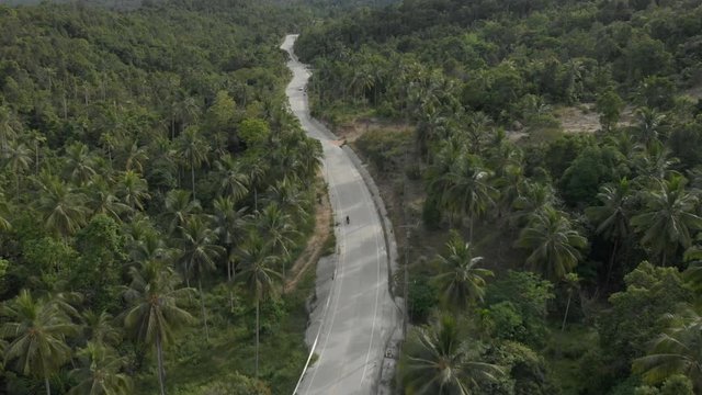 3 flat aerial shots in cinelike-D. Biker riding motorcycle by the road