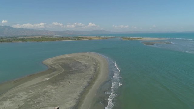 Aerial view of sandy beach Lingayen with azure water on the island Luzon, Philippines. Seascape, ocean and beautiful beach.