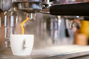 Close up of traditional Espresso Coffee Machine making cup of espresso coffee.