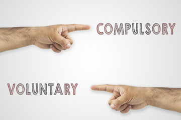 Antonym concept. Hands pointing to different sides. Voluntary or compulsory on white background.