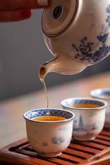Cropped shot of pouring tea in traditional chinese teaware.