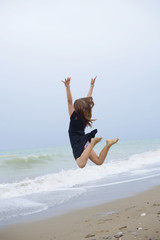 beautiful teen girl near the sea. littered the horizon