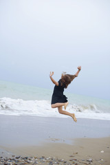 beautiful teen girl near the sea. littered the horizon